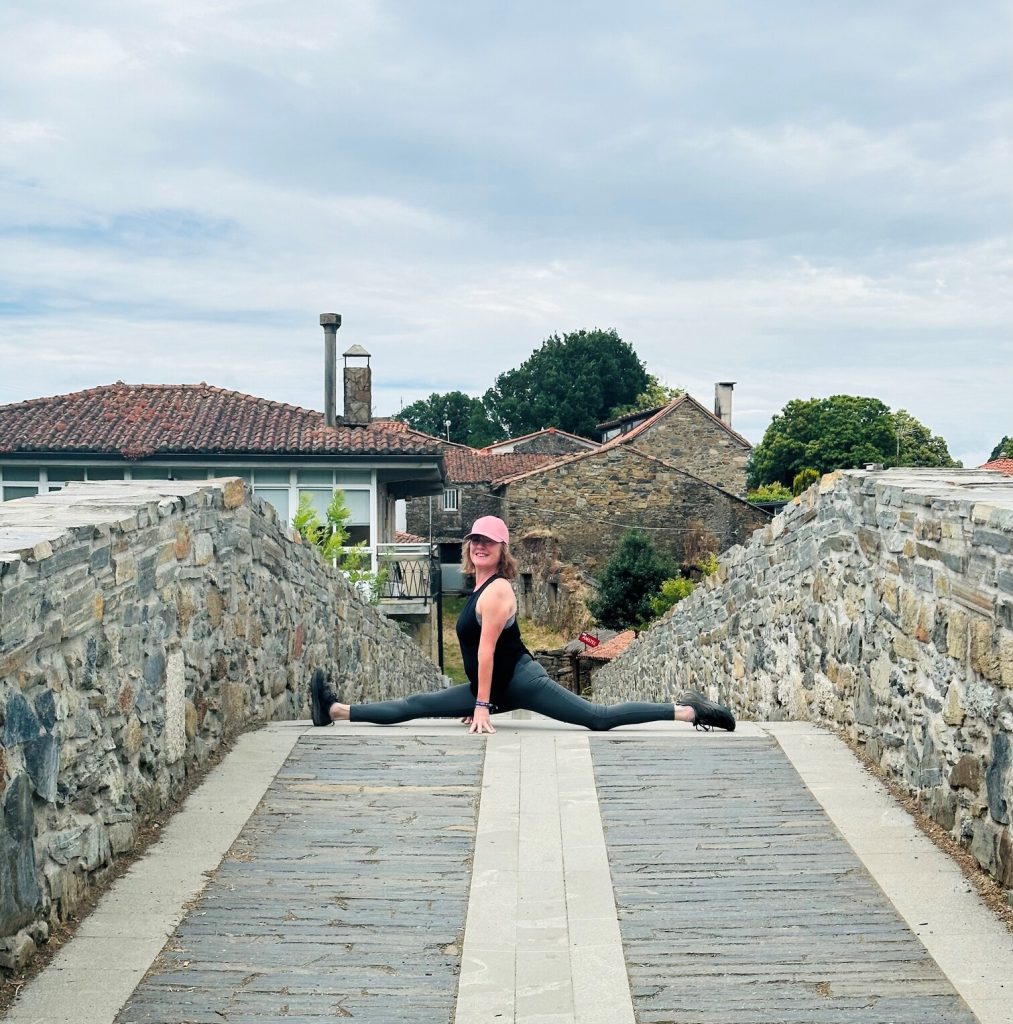 “Pilgrim doing yoga outdoors on the Camino de Santiago, Galicia, Spain.”