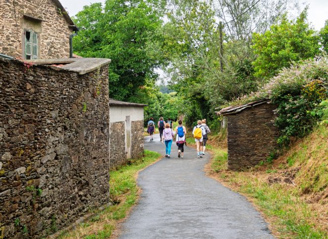 Camino Yoga Escape Pilgrims walking through villages on the Camino de Santiago, Galicia, Spain